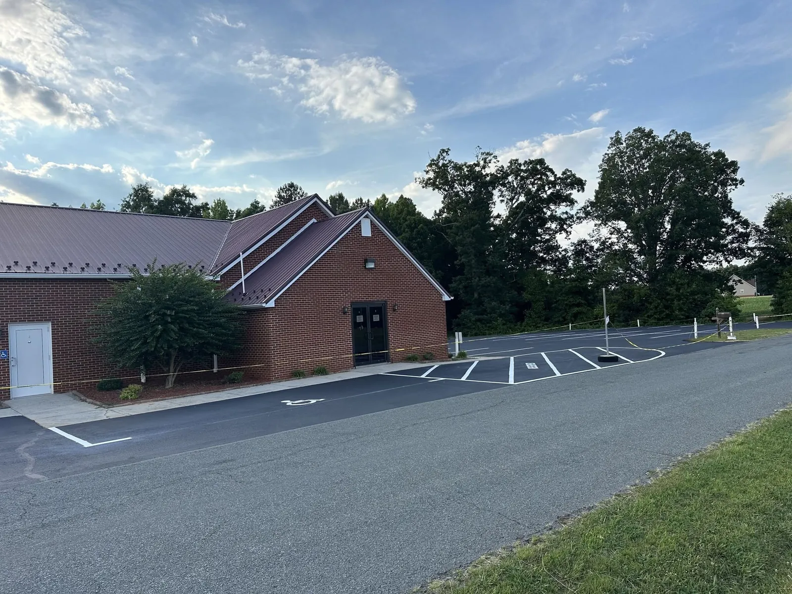 White parking lines on asphalt beside a brick church